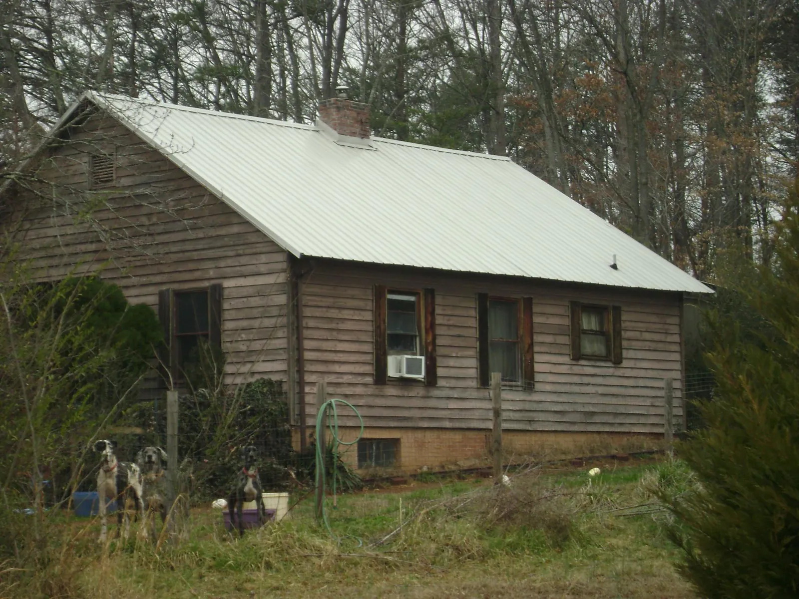 White metal roof on an old wood sided farmhouse, from a Metal Roof Installation job in Chatsworth
